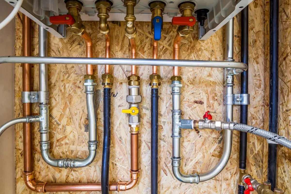Copper and PEX water supply lines with shut-off valves in an open wall