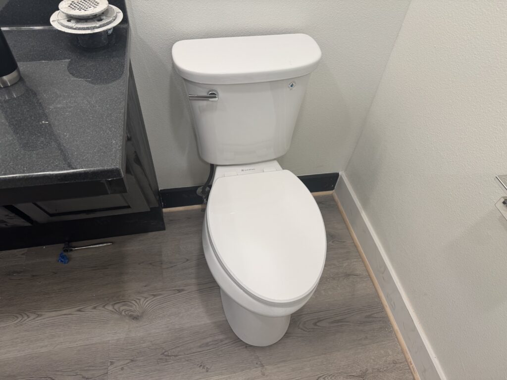 Newly installed white toilet in a modern bathroom