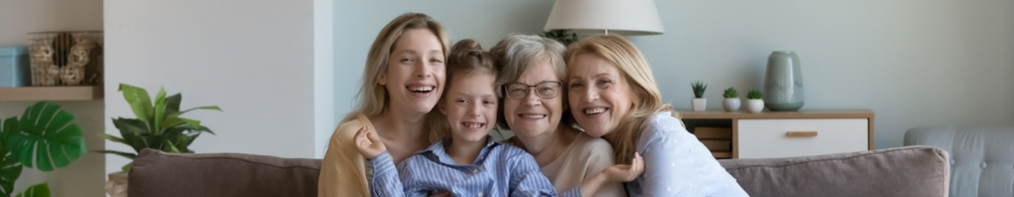 Family smiling together on a couch