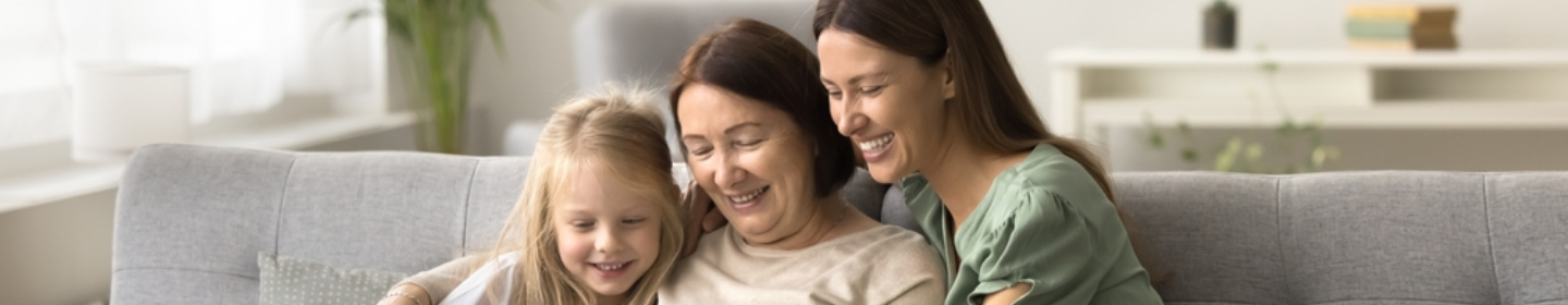 Family smiling together on a couch