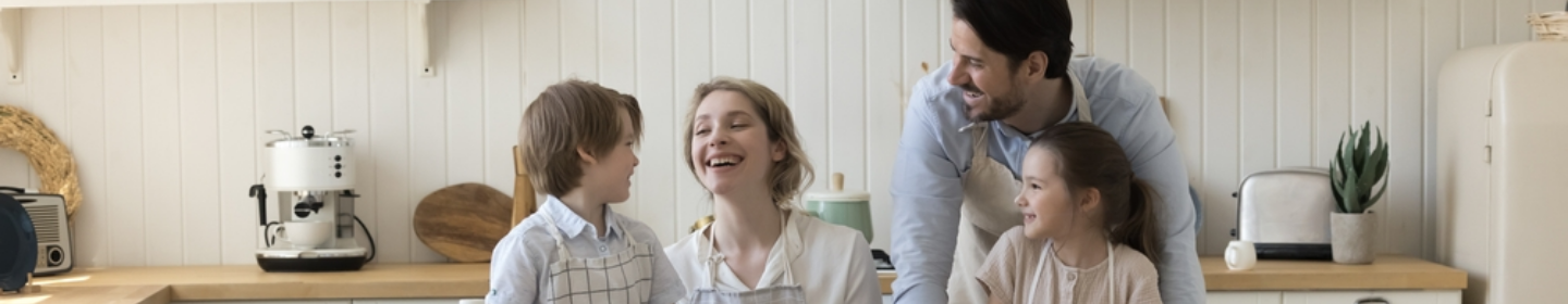 Family smiling together in a kitchen