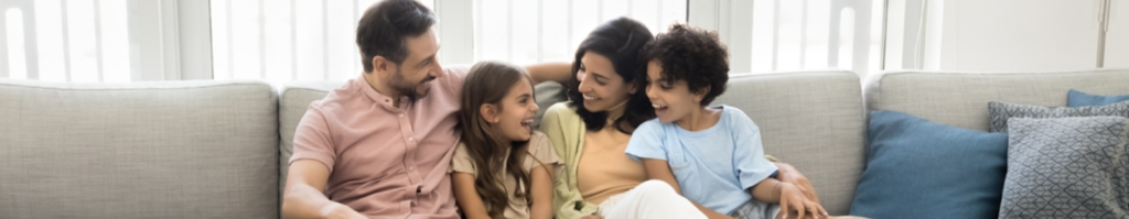 Family smiling together on a couch