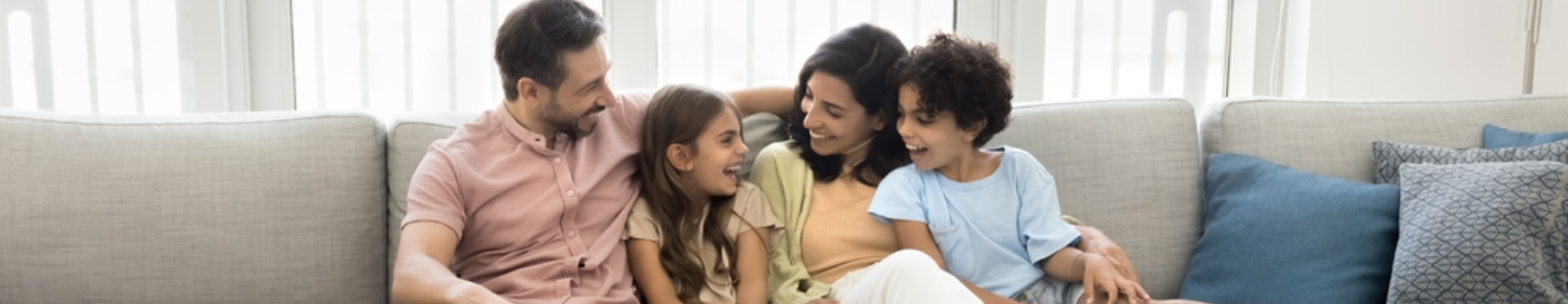 Family smiling together on a couch