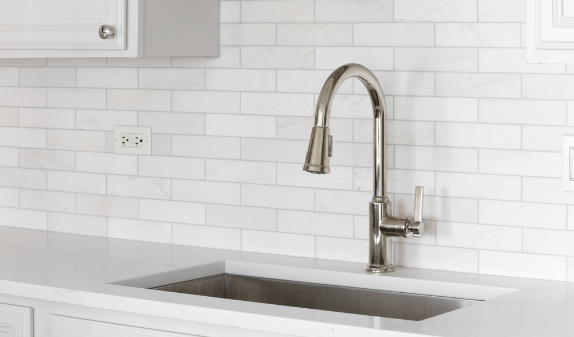 Brushed nickel faucet over a stainless kitchen sink