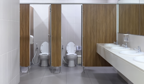 Commercial restroom with toilet stalls and sinks