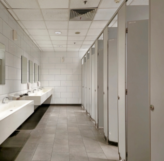 Commercial restroom with sinks and toilet stalls
