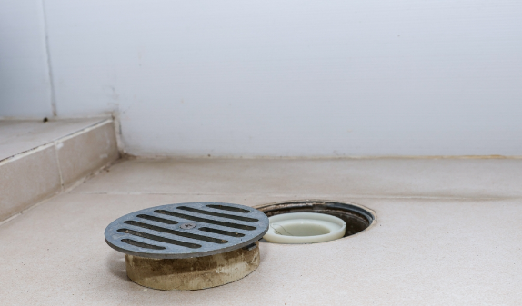 Floor drain grate in a concrete floor