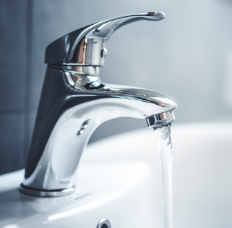 Chrome bathroom faucet with running water