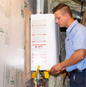 Technician installing a tankless water heater on a wall