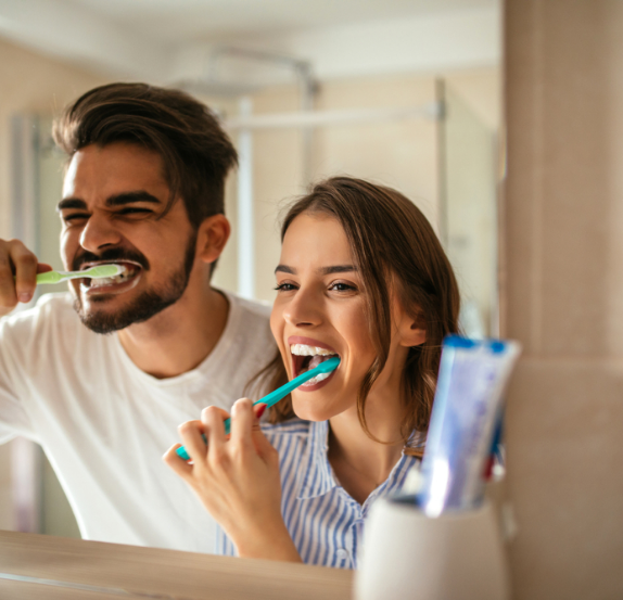 Couple brushing their teeth together