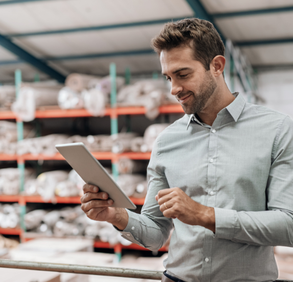 Man with a tablet in a commercial storeroom