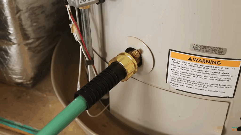 Garden hose connected to a water heater drain valve for flushing