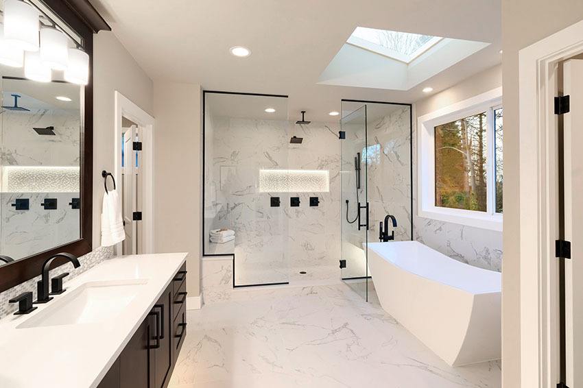 Remodeled bathroom with a glass shower, freestanding tub and double vanity