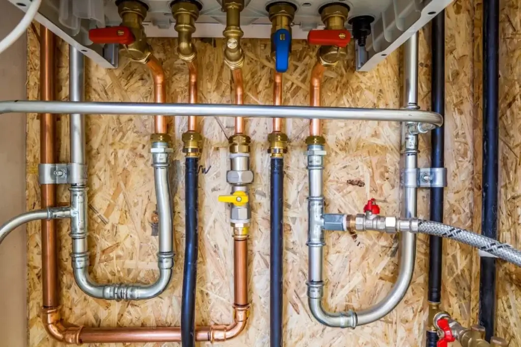 Copper and PEX water supply lines with shut-off valves in an open wall
