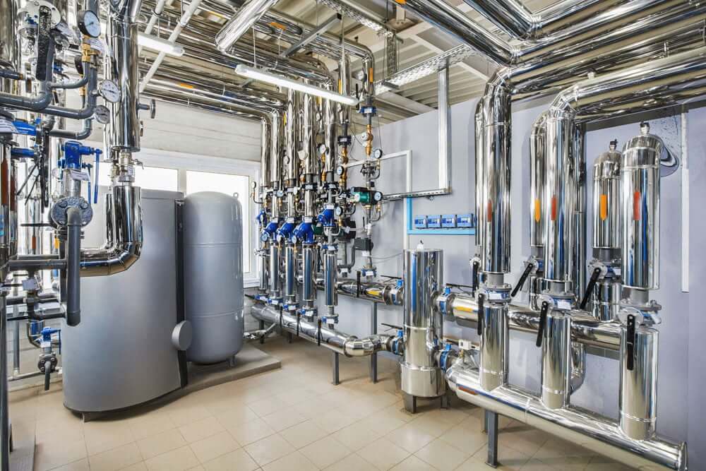 Commercial mechanical room with insulated pipes and tanks