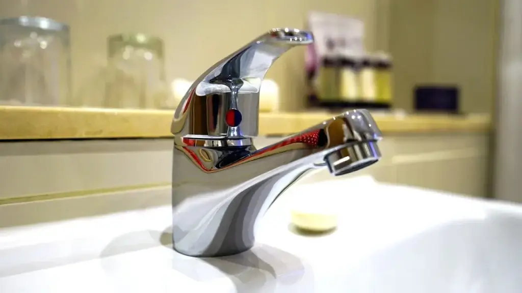 Chrome bathroom faucet with running water