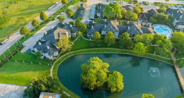 Aerial view of Alamo Heights homes around a pond