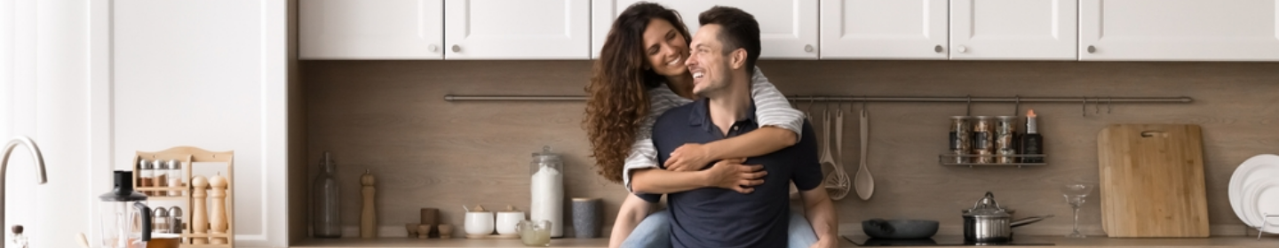 Couple embracing in a modern kitchen