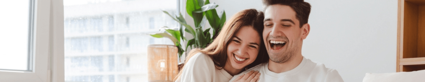 Smiling couple in a bright living room