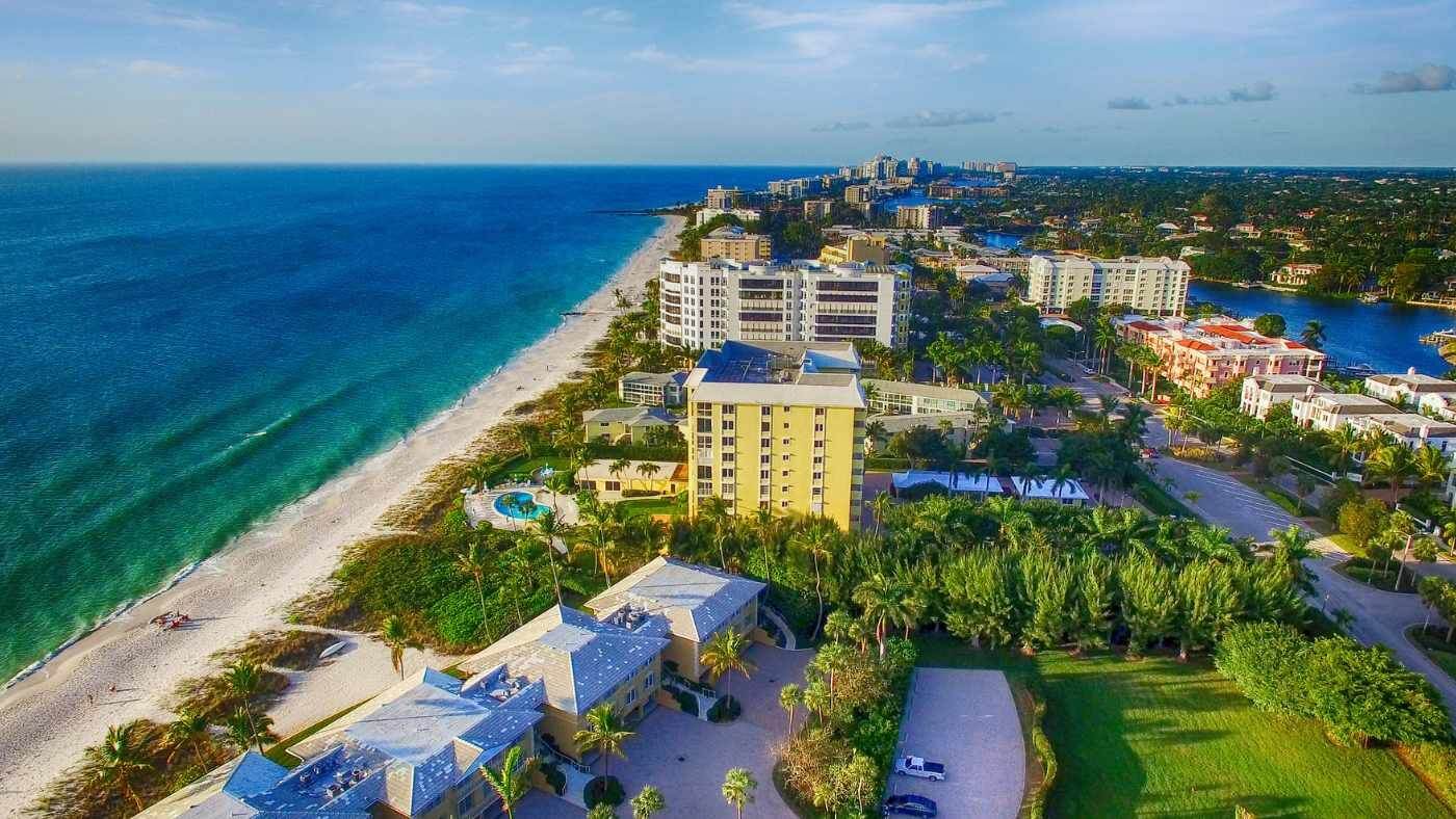 Aerial view of a beach, coastline and waterfront buildings