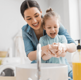 Mother and daughter washing their hands together