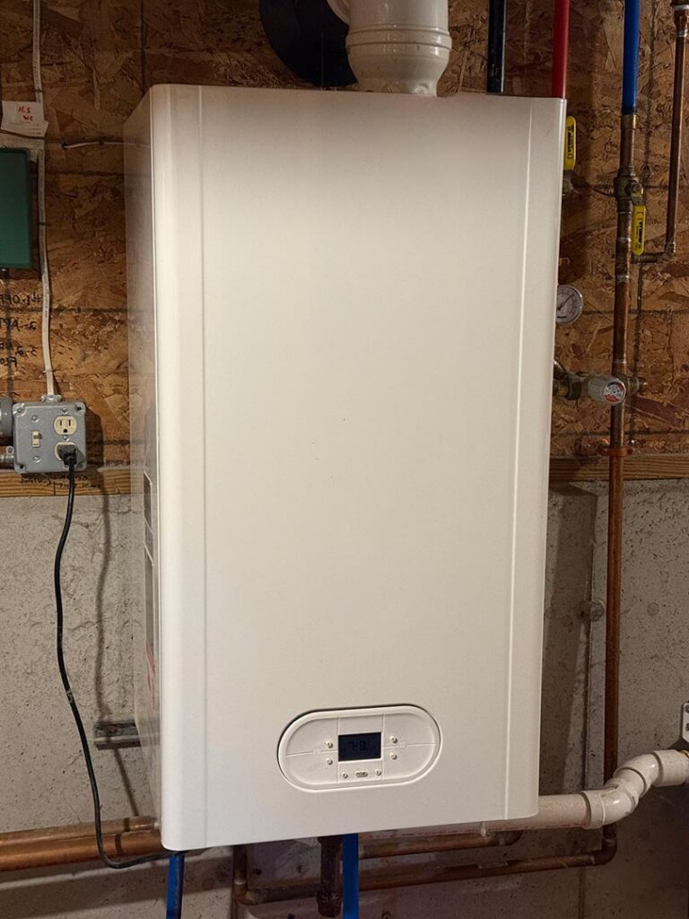 Wall-mounted tankless water heater in a utility room