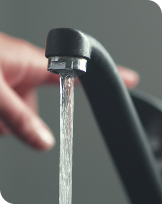Water running from a black kitchen faucet