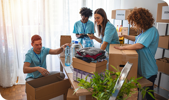 Volunteers in matching shirts sorting donations into boxes