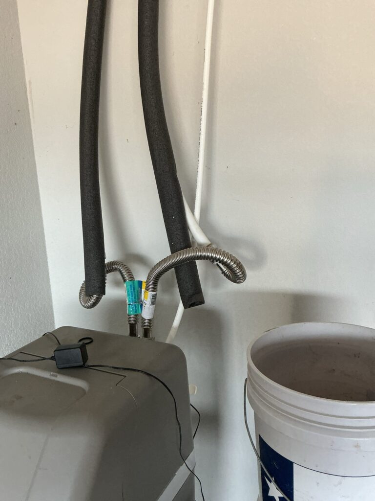 Insulated water lines with leaking connections above a water softener before repair