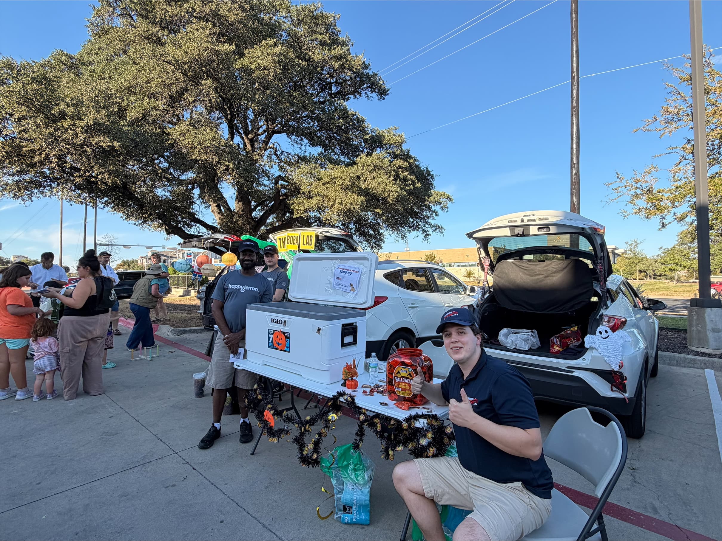 PlumbingPro team at a community trunk-or-treat event in a parking lot